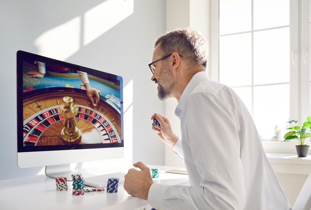 Mature,Man,Gambler,In,Glasses,And,White,Shirt,Places,Bet