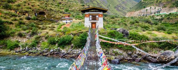 TravMedia_United_Kingdom_medium-sized_1673981_Iron-Chain-Bridge-of-Tamchog-Lhakhang-Monastery-Paro-River-Bhutan-1400-1400x550-c-default