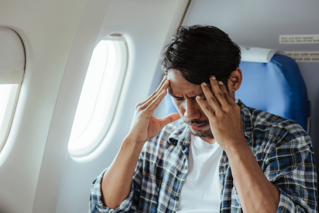 Headache,On,Airplane,Male,Passenger,Is,Afraid,And,Feels,Bad
