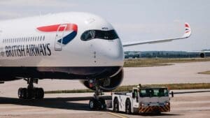 The morning light filters through the plate-glass windows of British Airways’ Waterside headquarters at Heathrow, casting long reflections across the quiet atrium. Outside, jets lift steadily into the sky, each one a reminder of the tension at the heart of modern aviation: an industry built to connect the world, yet under immense pressure to curb its carbon footprint.