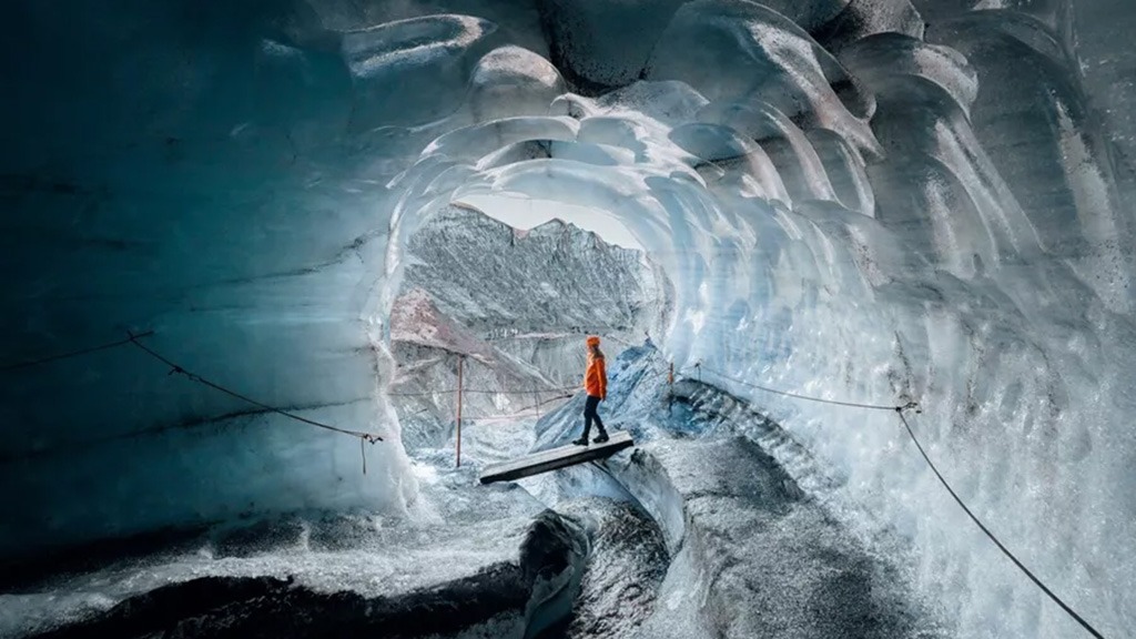 When winter returns to Iceland, the landscape transforms into something almost otherworldly. Beneath the glaciers, a hidden world stirs to life — a labyrinth of ice caves that shimmer in shades of blue, silver and ash-black, forming anew each year as freezing water sculpts the glacier’s heart.