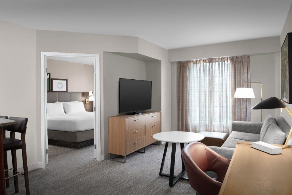 IHG SILVERDOOR PARTNERSHIP IMAGE - Guest room at Staybridge Suites Downtown Columbia featuring a separate living area, work desk and full sized appliances