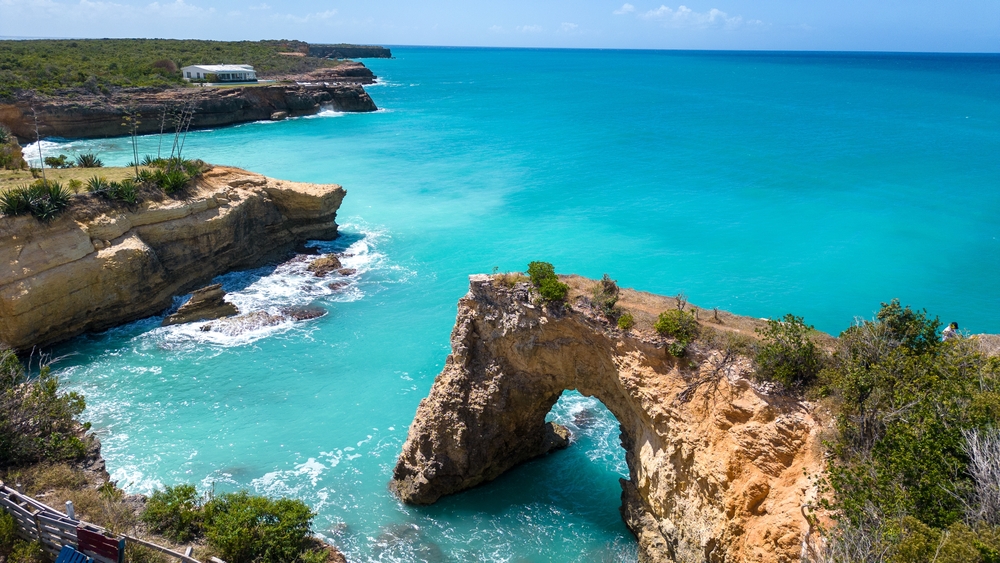 Anguilla,Arch.,Natural,Hole,Carved,In,The,Rock.,Turquoise,Sea