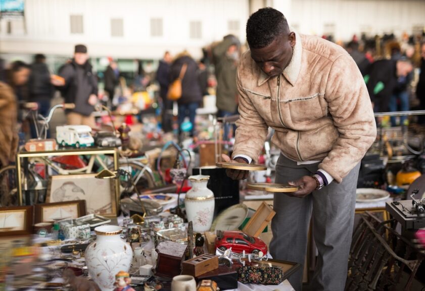 Afro-american,Guy,Considers,Things,Sacond,Hands,On,Flea,Market