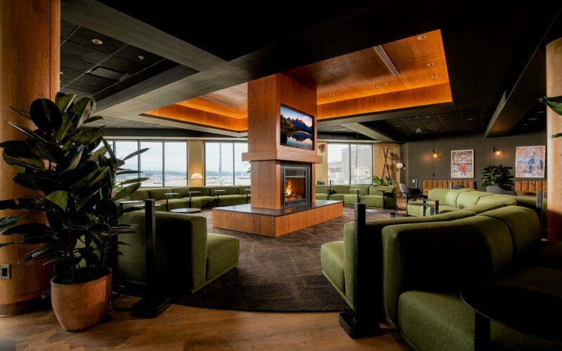 Seating and wood panelling inside the Calgary airport Amex lounge in Concourse A at YYC