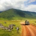 Safari,In,Ngorongoro,Crater,National,Park.,Zebras,Against,Mountains,And