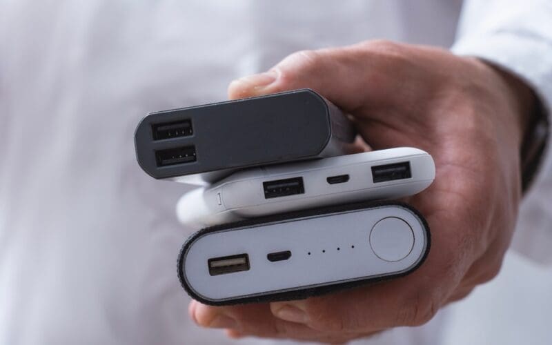 Power bank and smartphone on an aircraft seat tray, with airline power bank rules limiting passengers to two