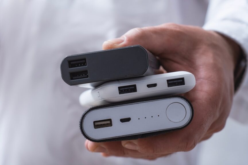 Power bank and smartphone on an aircraft seat tray, with airline power bank rules limiting passengers to two