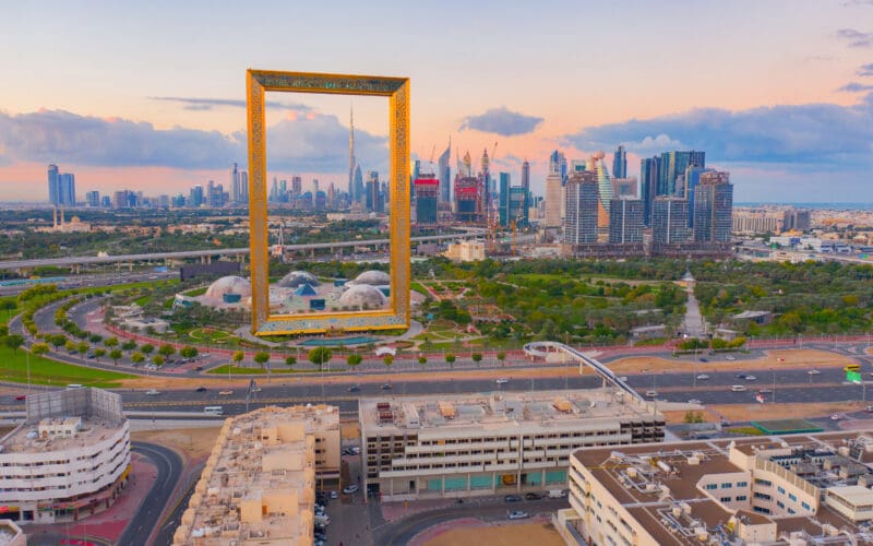Aerial view of Dubai Frame, Downtown skyline, United Arab Emirates or UAE. Financial district and business area in smart urban city. Skyscraper and high-rise buildings at sunset.