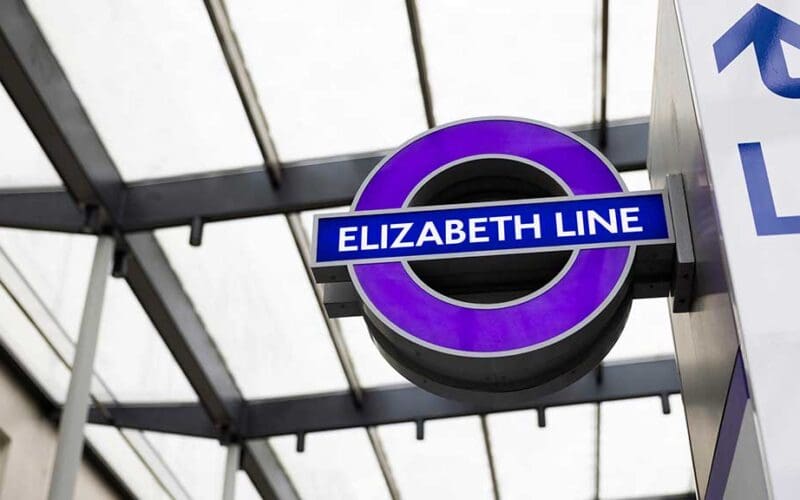 Station staff providing Elizabeth line passenger assistance on a step-free platform in London